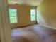 Spacious bedroom featuring neutral walls, carpeted floor, and two windows for ample natural light at 1570 Twin Bridge Ln, Lawrenceville, GA 30043