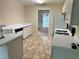 Functional kitchen with white cabinetry, countertops, and appliances, with view into the dining room at 1570 Twin Bridge Ln, Lawrenceville, GA 30043