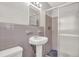 Cozy bathroom featuring a pedestal sink, tiled walls, and glass enclosed shower at 2261 Star Mist Sw Dr, Atlanta, GA 30311