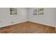 Sunlit bedroom featuring hardwood floors, two windows, and fresh paint at 2261 Star Mist Sw Dr, Atlanta, GA 30311