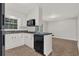 Open kitchen layout with dark appliances, white cabinets, and a breakfast bar area at 2261 Star Mist Sw Dr, Atlanta, GA 30311