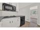 White kitchen featuring dark appliances, ample counter space and natural light from a window at 2261 Star Mist Sw Dr, Atlanta, GA 30311