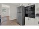 Clean kitchen with stainless steel appliances, white cabinets, and view into adjacent room at 2261 Star Mist Sw Dr, Atlanta, GA 30311