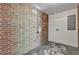 Functional utility room with brick wall, concrete floor, and white wood paneled accents at 2261 Star Mist Sw Dr, Atlanta, GA 30311