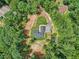 Aerial view of the home nestled among lush trees, highlighting the driveway and green space at 2725 Glendale Ne Dr, Conyers, GA 30013