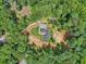 An aerial view of a home surrounded by trees, showcasing its private setting, distinctive roofline, and landscaping at 2725 Glendale Ne Dr, Conyers, GA 30013