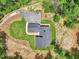 Aerial shot of a home with gray roof, stone front, sidewalk, driveway, landscaping, and a well-manicured lawn at 2725 Glendale Ne Dr, Conyers, GA 30013