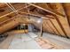 Unfinished attic with exposed wood beams and potential for future renovation and storage at 2725 Glendale Ne Dr, Conyers, GA 30013