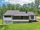 Back of home features a screened porch, white siding, and dark trim, plus a spacious lawn at 2725 Glendale Ne Dr, Conyers, GA 30013