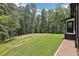 Expansive backyard featuring a lush lawn surrounded by mature trees, creating a private and serene outdoor space at 2725 Glendale Ne Dr, Conyers, GA 30013