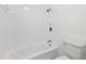 This bathroom has white tile and a combined tub and shower at 2725 Glendale Ne Dr, Conyers, GA 30013