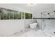 A soaking tub and glass shower are featured in this spacious bathroom with a large window at 2725 Glendale Ne Dr, Conyers, GA 30013