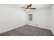 An empty bedroom with grey carpet and a ceiling fan at 2725 Glendale Ne Dr, Conyers, GA 30013