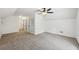 Spacious bedroom with plush carpeting, modern ceiling fan, and ample closet space at 2725 Glendale Ne Dr, Conyers, GA 30013