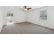 Spacious bedroom with large window, carpet flooring, and ensuite bathroom at 2725 Glendale Ne Dr, Conyers, GA 30013