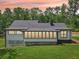 Exterior view of a home with large windows and a well-maintained lawn, set against a backdrop of lush trees at 2725 Glendale Ne Dr, Conyers, GA 30013
