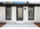 Charming front entrance with a stone facade, black trim, and an open doorway at 2725 Glendale Ne Dr, Conyers, GA 30013