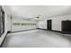 View of the garage with an automated door and painted floors, white walls, and black trim at 2725 Glendale Ne Dr, Conyers, GA 30013