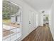 Bright hallway with wood floors, a large window, and white walls for a clean look at 2725 Glendale Ne Dr, Conyers, GA 30013