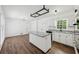 Bright kitchen with white cabinets, a central island, hardwood floors, and a casual dining area at 2725 Glendale Ne Dr, Conyers, GA 30013