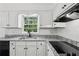 Bright kitchen featuring granite counters, white cabinets, and stainless appliances at 2725 Glendale Ne Dr, Conyers, GA 30013