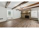 Bright living room with stone fireplace, wood beams, and hardwood floors at 2725 Glendale Ne Dr, Conyers, GA 30013