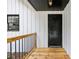 View of the covered porch with a wooden deck, dark trim, and white siding at 2725 Glendale Ne Dr, Conyers, GA 30013
