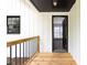 Exterior view of a white-sided home's porch with wooden deck and black railing at 2725 Glendale Ne Dr, Conyers, GA 30013