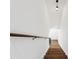 Bright staircase featuring hardwood steps, white walls, and a unique overhead light fixture at 2725 Glendale Ne Dr, Conyers, GA 30013