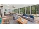 Staged sunroom with a sofa and dining table offering views of the backyard at 2725 Glendale Ne Dr, Conyers, GA 30013