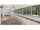 Sunroom filled with many windows, hardwood floors, and views of the backyard at 2725 Glendale Ne Dr, Conyers, GA 30013