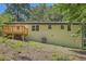 Exterior view of the home showcasing a wooden deck and a partially-wooded backyard at 290 Bromack Se Dr, Atlanta, GA 30315