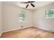 Bright bedroom with hardwood floors, ceiling fan, and two windows offering natural light at 290 Bromack Se Dr, Atlanta, GA 30315