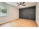 Stylish bedroom with a modern accent wall and bright, wood-look floors at 290 Bromack Se Dr, Atlanta, GA 30315