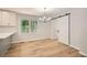 Dining area with sliding barn door, hardwood floors, modern lighting, and a view of the backyard at 290 Bromack Se Dr, Atlanta, GA 30315