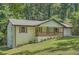 Home displays an updated exterior, established landscaping and mature trees at 290 Bromack Se Dr, Atlanta, GA 30315