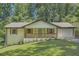 Inviting home boasts a freshly manicured lawn, charming porch and updated brick exterior at 290 Bromack Se Dr, Atlanta, GA 30315