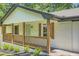 Close up of a covered front porch with wooden rails and brick accents at 290 Bromack Se Dr, Atlanta, GA 30315