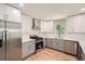 Modern kitchen featuring stainless steel appliances, gray lower cabinets, and white upper cabinets at 290 Bromack Se Dr, Atlanta, GA 30315