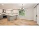 Open-concept kitchen with gray cabinets, stainless steel appliances, and quartz countertops next to dining area at 290 Bromack Se Dr, Atlanta, GA 30315