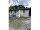 Rear view of a small home featuring a modest entrance and a fenced yard at 303 Anderson Nw Ave, Atlanta, GA 30314