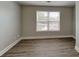 Bedroom with hardwood floors, neutral paint, and natural light from a window at 1232 Pinedale Nw Cir, Conyers, GA 30012