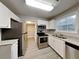 Modern kitchen with stainless steel appliances, granite countertops, and white cabinets at 1232 Pinedale Nw Cir, Conyers, GA 30012