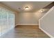 Bright living room features hardwood floors, recessed lighting, and a sliding glass door to the backyard at 1232 Pinedale Nw Cir, Conyers, GA 30012