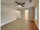 Spacious bedroom with hardwood floors, ceiling fan, neutral paint, and ensuite bathroom at 1232 Pinedale Nw Cir, Conyers, GA 30012