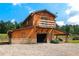 Exterior of the barn with a balcony, covered area, and stone accents on the lower portion at 1780 Penn Camp Road, Douglasville, GA 30134
