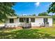 Charming exterior of a white home with black shutters, complemented by a well-manicured lawn at 1780 Penn Camp Road, Douglasville, GA 30134