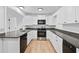 Bright kitchen with white cabinetry, stainless steel appliances, and sleek granite countertops at 1780 Penn Camp Road, Douglasville, GA 30134