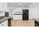 Well-lit kitchen features white cabinets, granite countertops, and modern appliances at 1780 Penn Camp Road, Douglasville, GA 30134