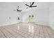 Large living room with tile floors, white walls, and French doors leading to the backyard at 1780 Penn Camp Road, Douglasville, GA 30134